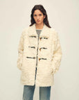 Woman wearing the Moro Garden white water ripple sheepskin coat, front view