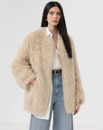 Model wearing the Peach Oolong morning mist white Toscana sheepskin winter coat, close front view