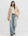 Model wearing the Peach Oolong morning mist white Toscana sheepskin winter coat, full-length view