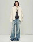 Model wearing the Practical Wearism cream white Toscana sheepskin coat, full-length view