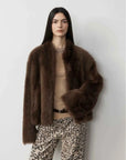 Model wearing the Practical Wearism mocha brown Toscana sheepskin coat, front view