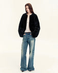 Woman wearing the Quiet Warmth black Merino shearling jacket, full-length view