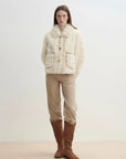 Model wearing the Rachel off-white two-tone curly wool shearling coat, relaxed full-length view