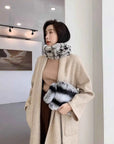 Woman styling a grey rex rabbit fur neck scarf with a neutral winter coat