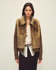 Model wearing the Silky Cocoa amber brown shearling coat, front view