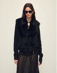Model wearing the Silky Cocoa black shearling coat, close front view