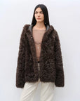 Woman wearing the Winter Snow brown hooded Toscana shearling coat, front view