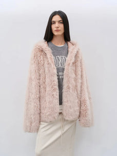 Woman wearing the Winter Snow dirty pink hooded Toscana shearling coat, front view