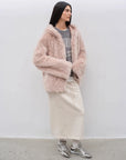 Woman styling the Winter Snow dirty pink hooded shearling coat, full-length view