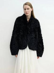 Model wearing the Yorta black Toscana curly shearling jacket
