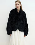 Model wearing the Yorta black Toscana curly shearling jacket