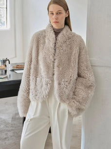 Yorta morning cloud gray curly shearling jacket styled on model