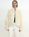Model wearing the Yorta white Toscana curly shearling jacket