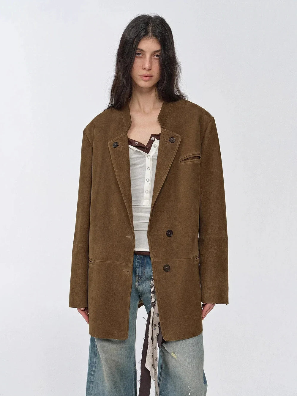 Brown leather blazer over a visible fall base layer