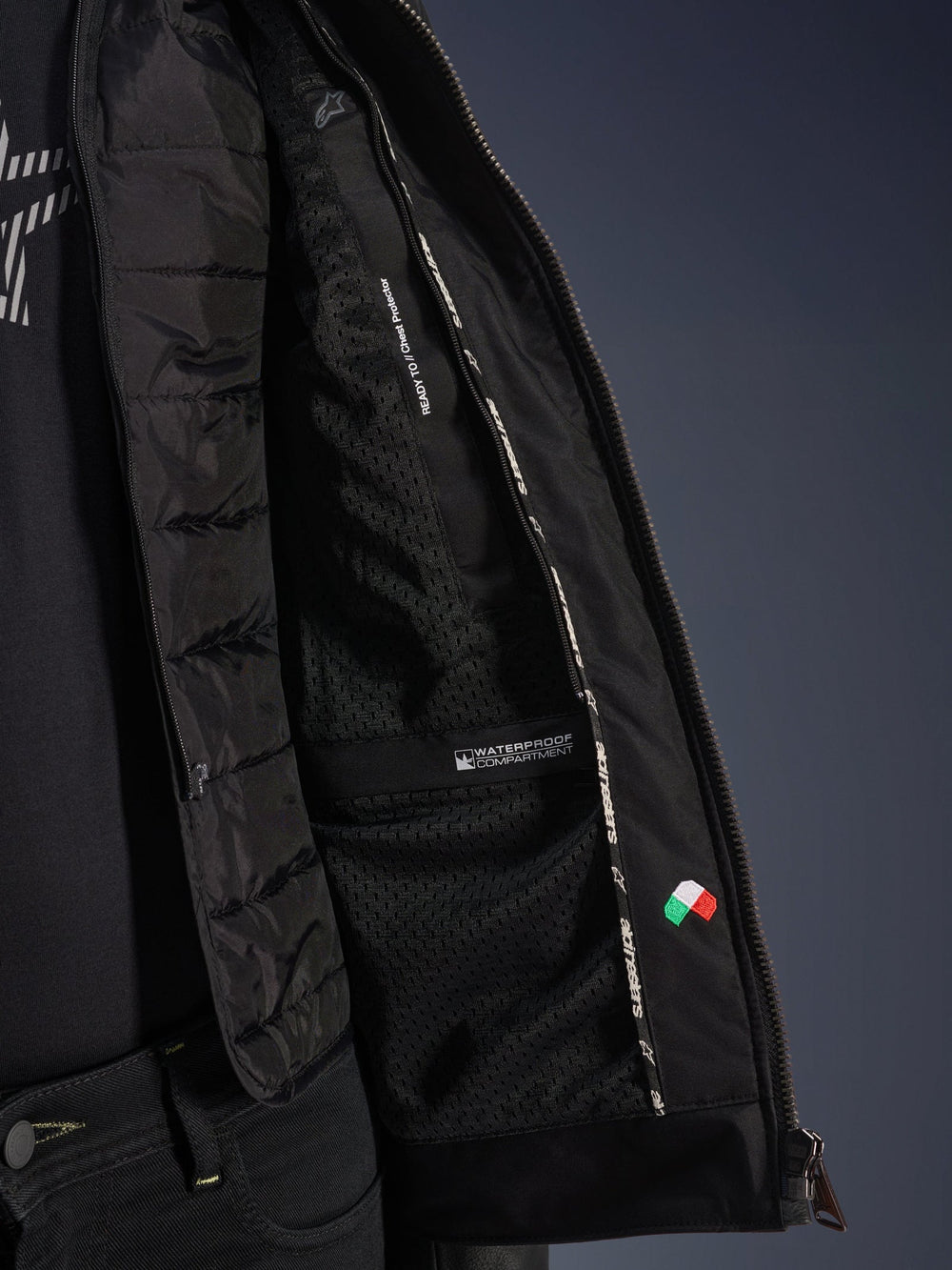 Partly open Alpinestars Blacktrack interior with quilted insert beside inner lining