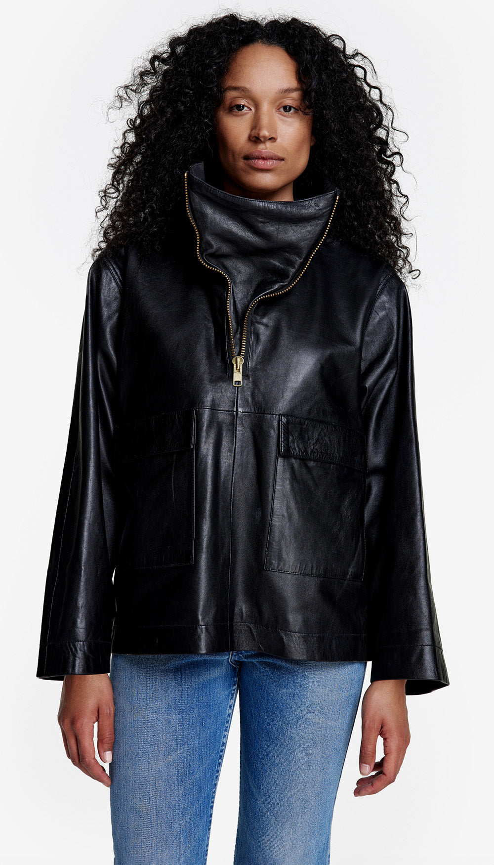 Black pullover with a short front zipper, funnel neck, closed lower front and two large patch pockets.