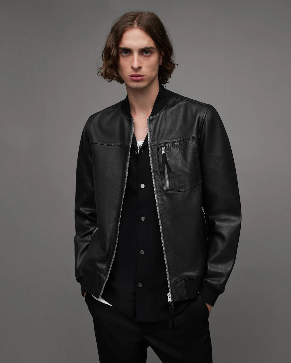 Black bomber jacket front with ribbed neck, cuffs and hem, zip front and chest pocket.
