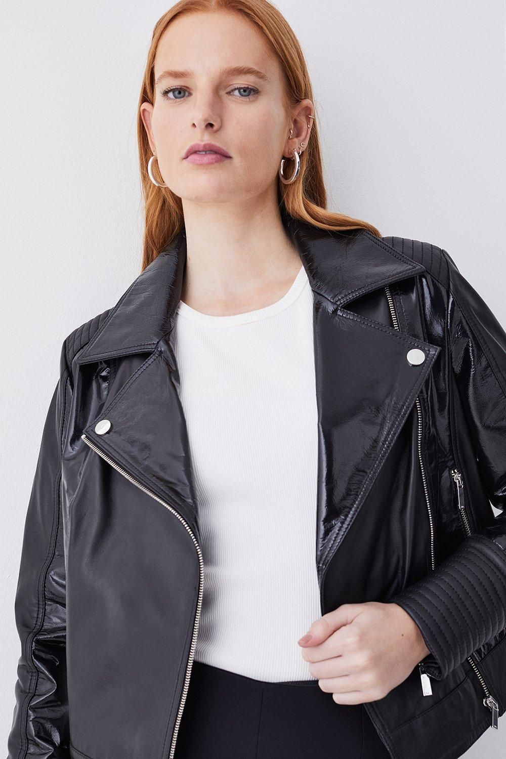 Karen Millen upper-body view shows glossy lapels/front panels, zip front and visibly different reflections across sleeves and body