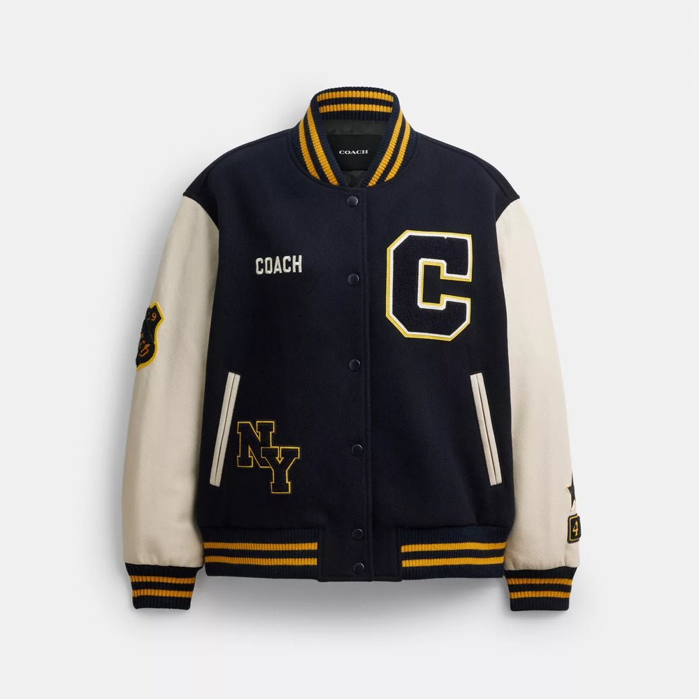 Coach CDK37 combines a wool-blend body and goat-leather sleeves according to the maker; the contrast panels and striped ribbing are visible here.