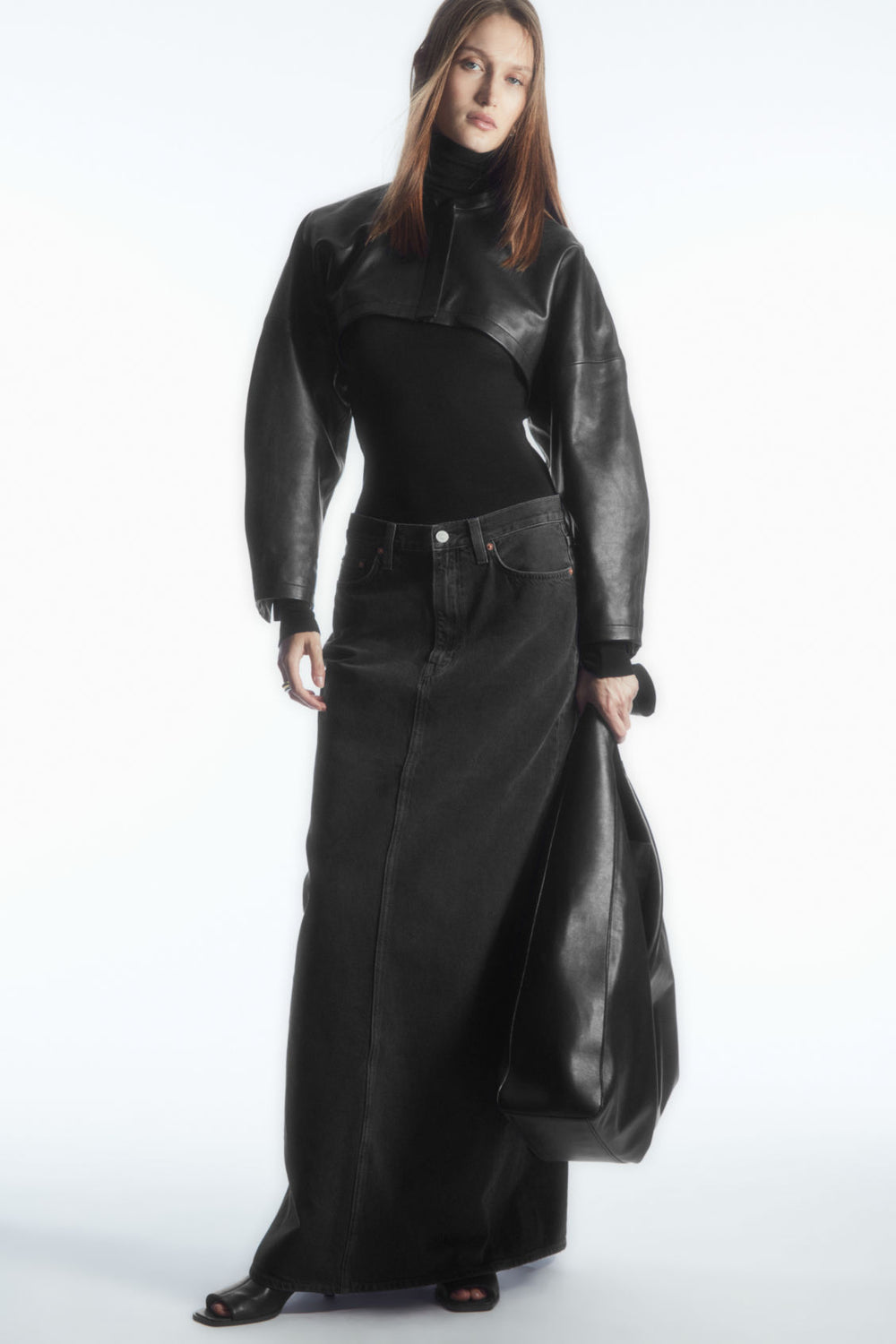 the very short leather front leaves the black base layer visible, while the sleeves extend much farther down.