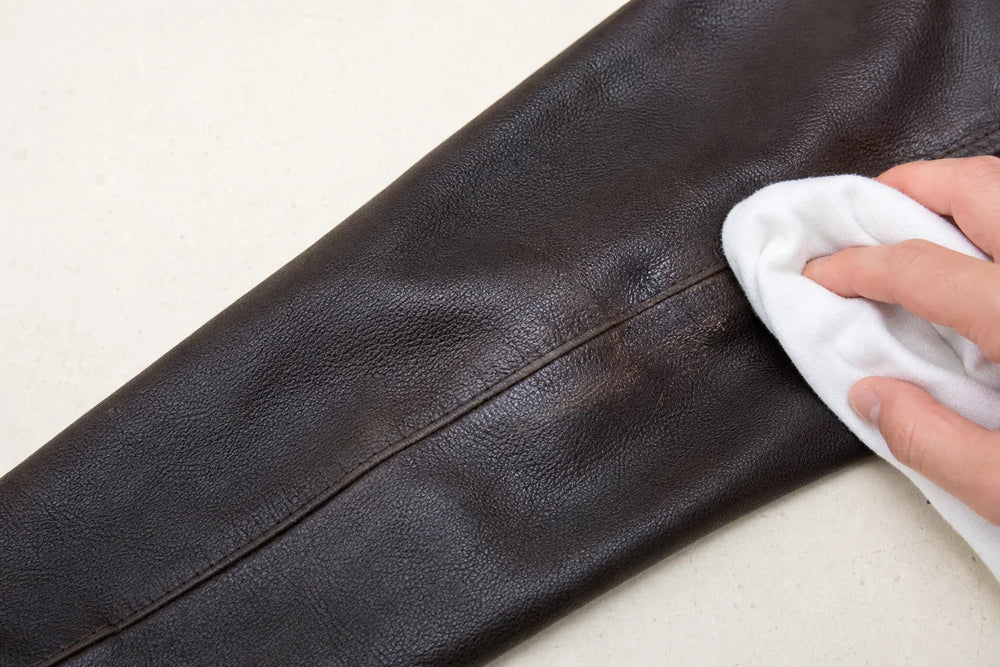 Leather grain and finish inspected under even light before conditioning
