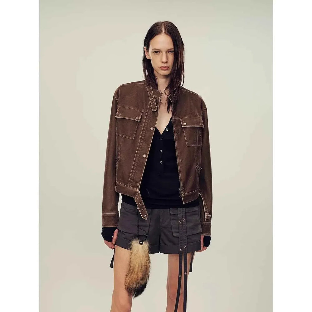 Short brown leather bomber jacket showing a compact blouson body and gathered hem