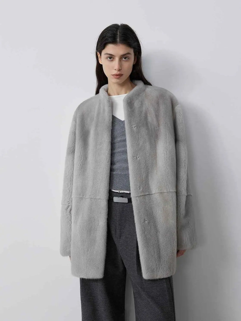 Hera Moonlight gray mink coat worn open on a model over a gray knit and dark trousers