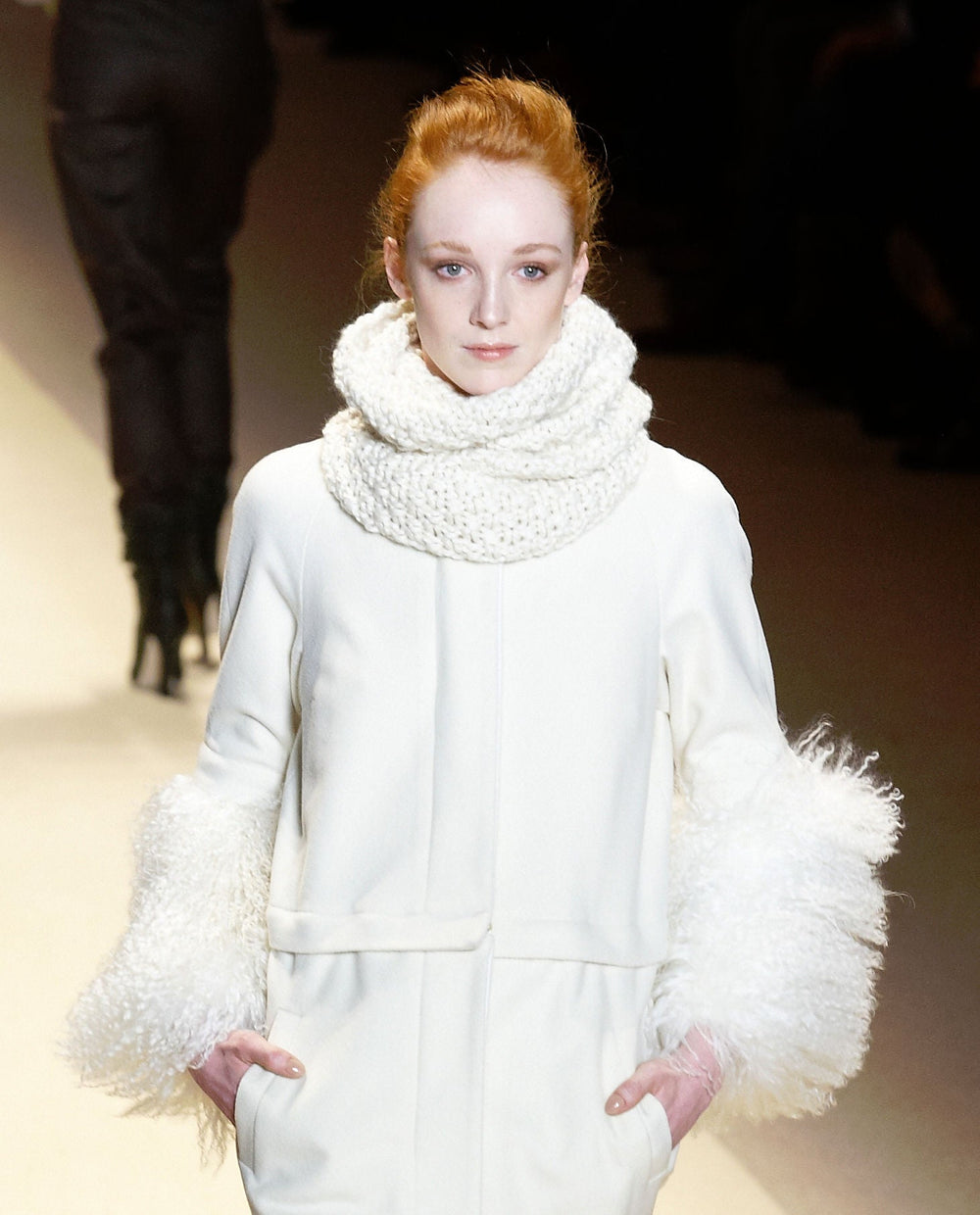 ADAM Fall-Winter 2010 model wearing a smooth pale coat with long curled cuff trim; photo Masaki-H, CC BY 2.0