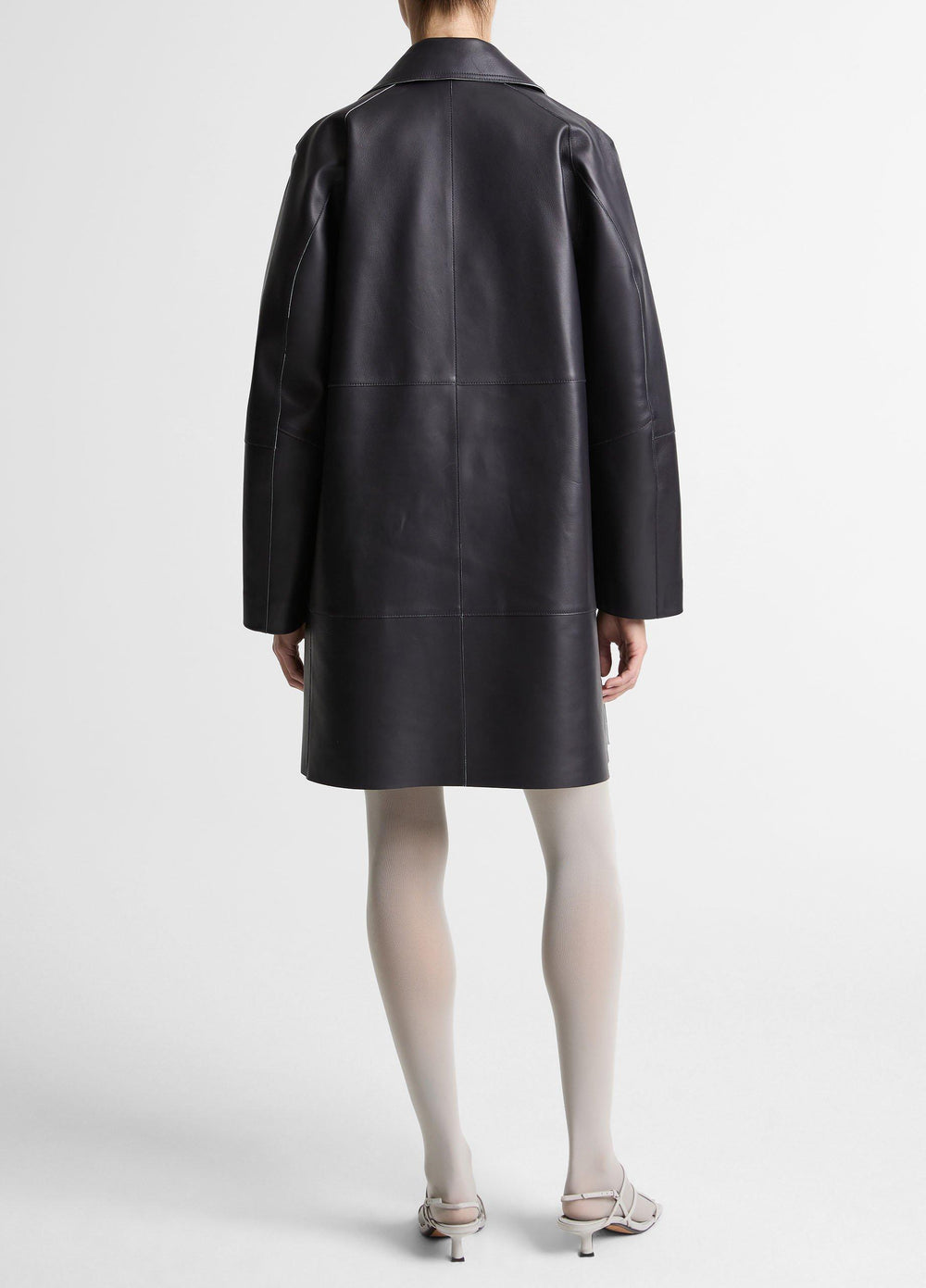 Rear view of a black Vince coat with back-panel seams.