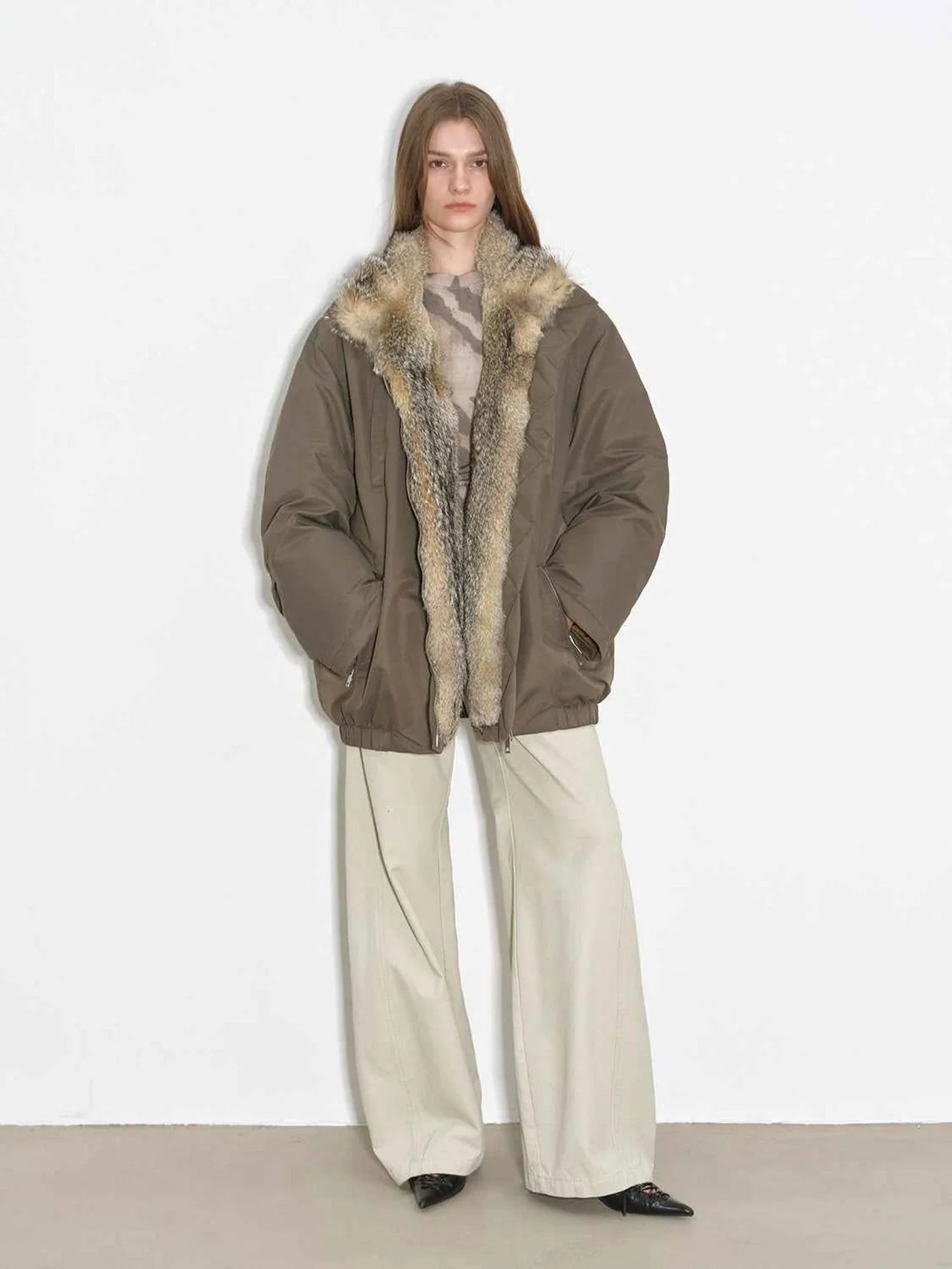 Model wearing Fireladyfur Travel Notes sand green warm winter down jacket with fluffy fox fur collar