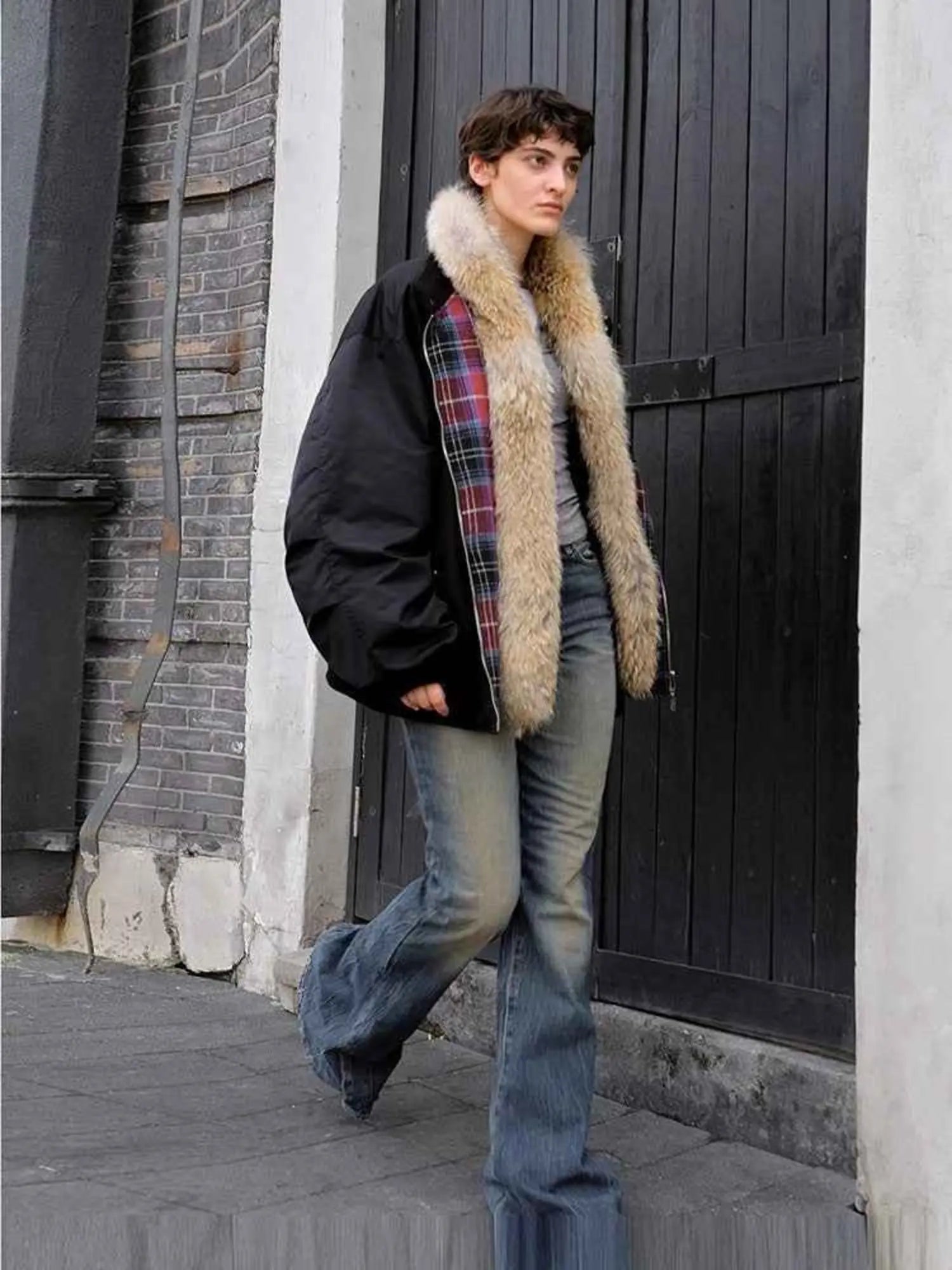 Model walking in Firelady Fur Urban Warmth women's Black detachable wolf fur collar parka