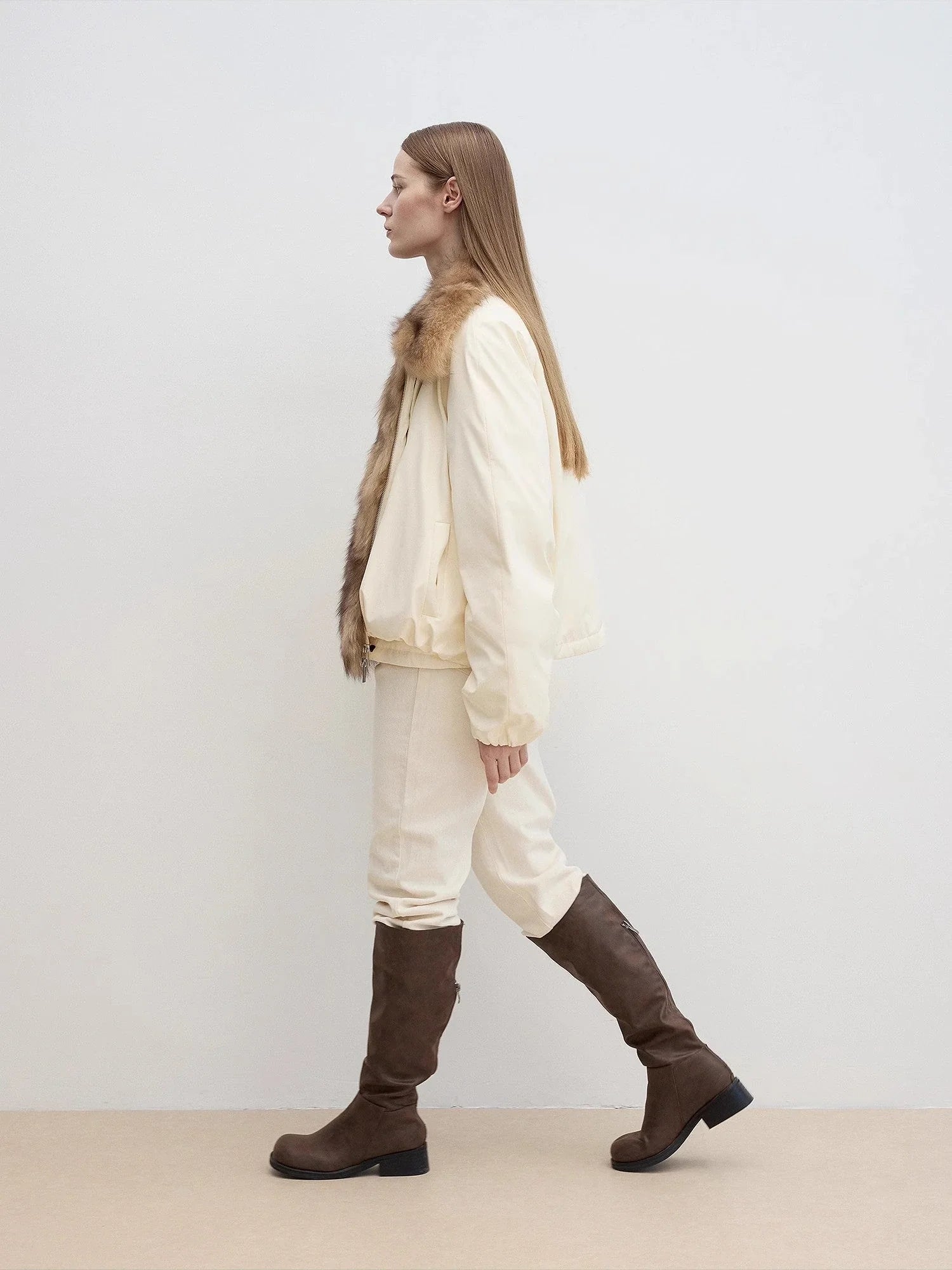 Side walking model view of Fireladyfur Day and Night Rider off-white detachable fox fur collar down jacket