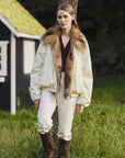Outdoor model view of Fireladyfur Day and Night Rider off-white down jacket with fox fur collar