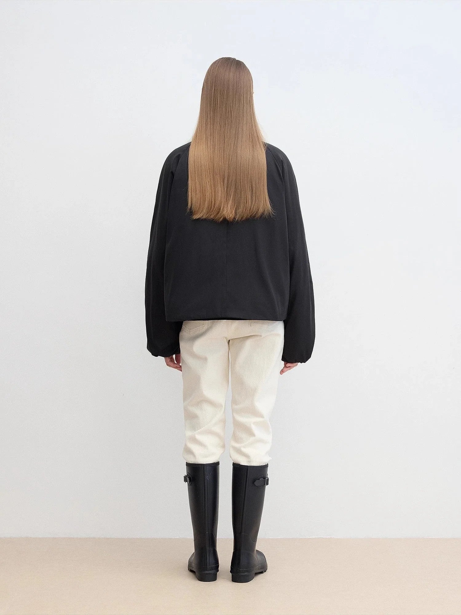 Back view of Fireladyfur Day and Night Rider black down jacket showing relaxed parka silhouette