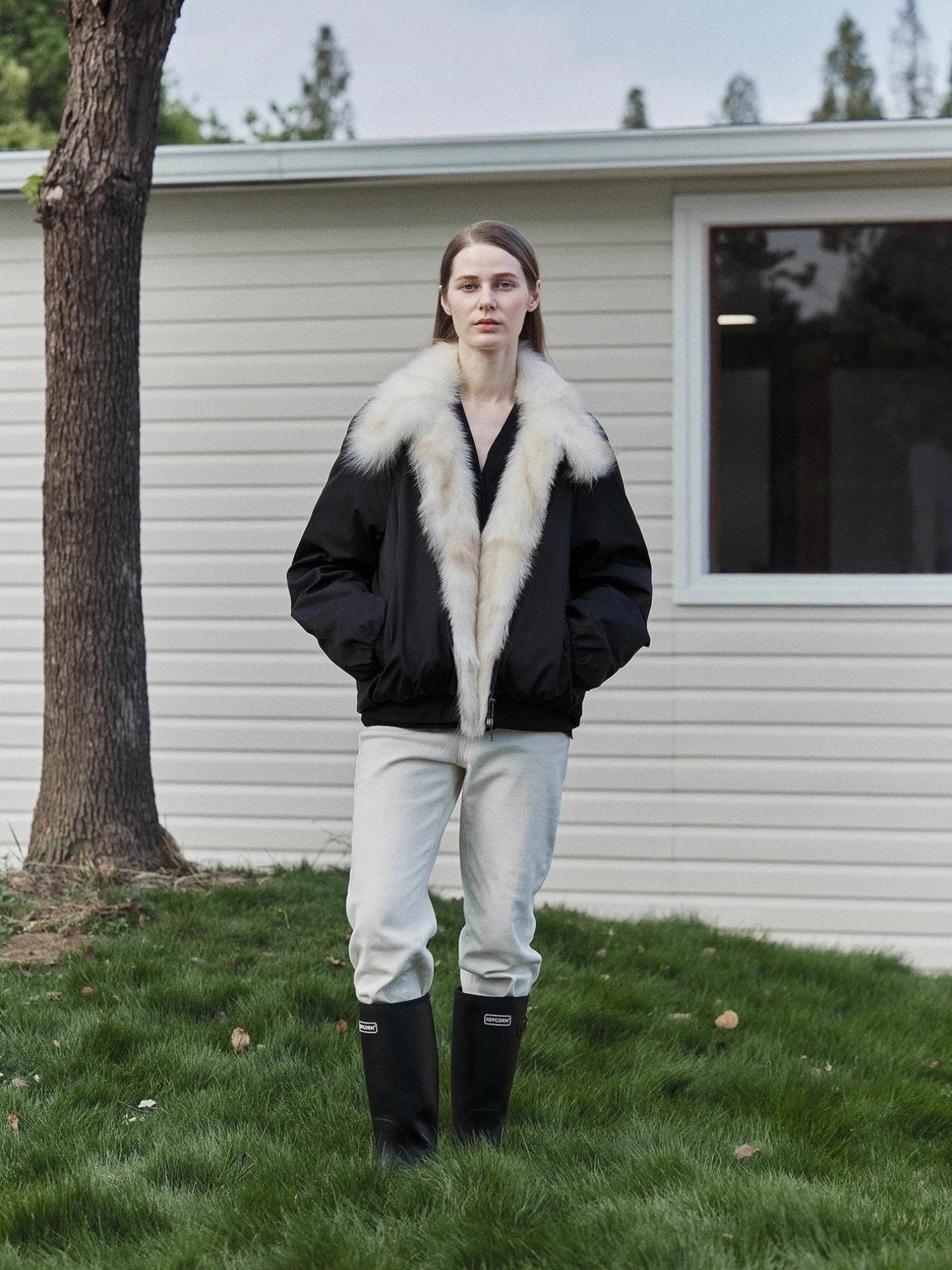 Outdoor model view of Fireladyfur Day and Night Rider black down jacket with contrasting fox fur collar