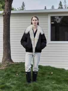 Outdoor model view of Fireladyfur Day and Night Rider black down jacket with contrasting fox fur collar