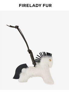 A white faux-fur horse-shaped bag charm with black accents, including a black mane, black tail, and black hanging strap, shown on a light gray background with the brand name 'FIRELADY FUR' at the top.