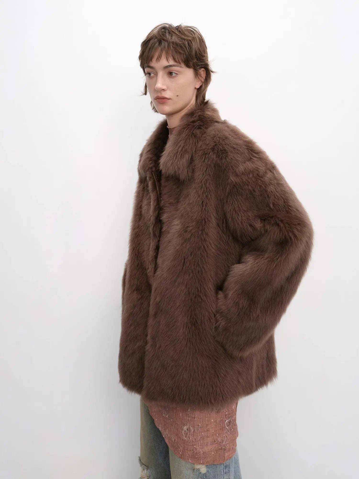 Woman modeling the cocoa brown Toscana shearling coat, side view
