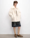 Woman styling the Autumn Exclusive off-white shearling coat, full-length view