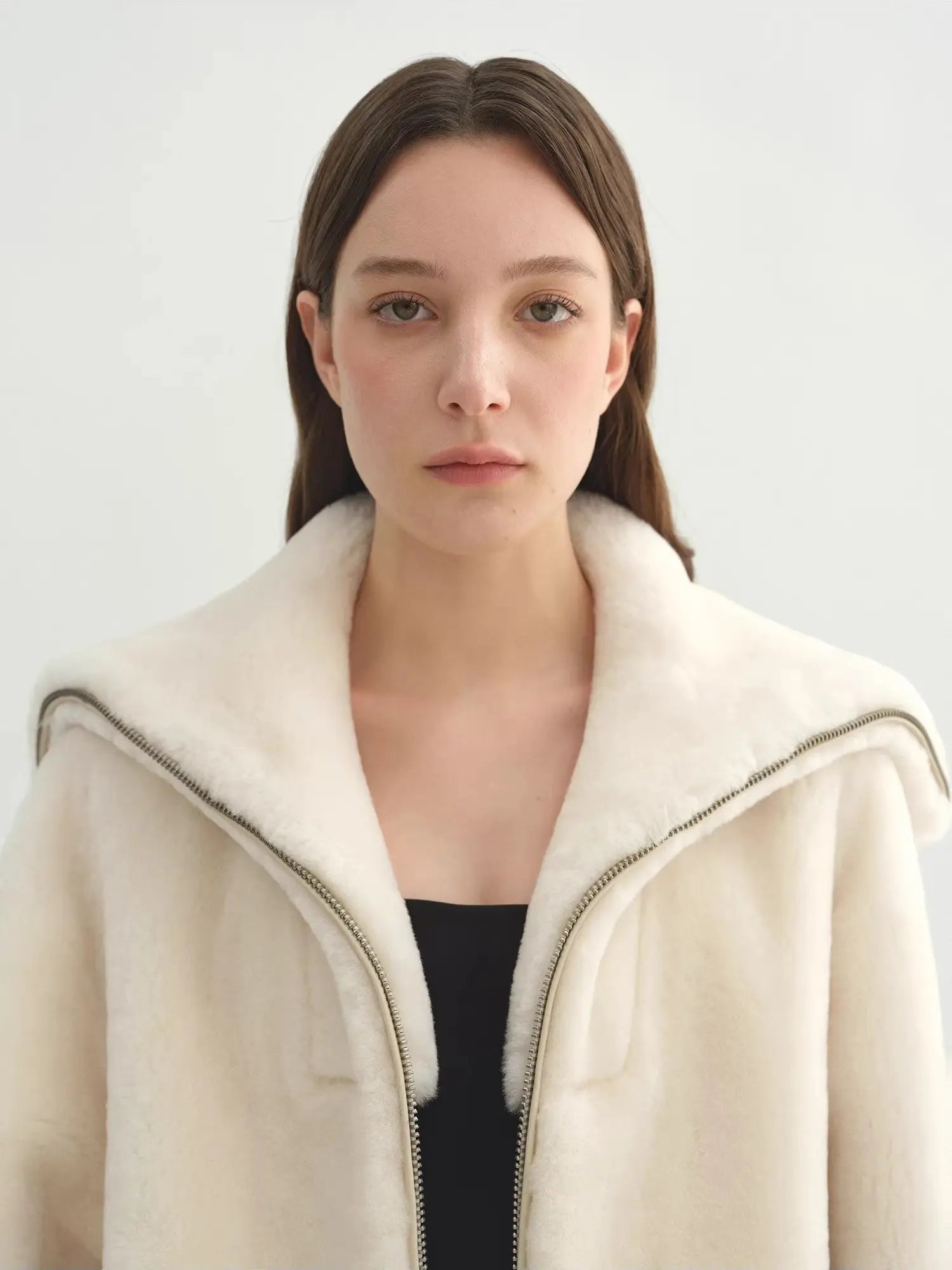 Model wearing the Butter Crisp pearl white Merino shearling leather coat, close collar view
