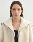 Model wearing the Butter Crisp pearl white Merino shearling leather coat, close collar view