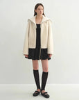 Model wearing the Butter Crisp pearl white Merino shearling leather coat, full-length view