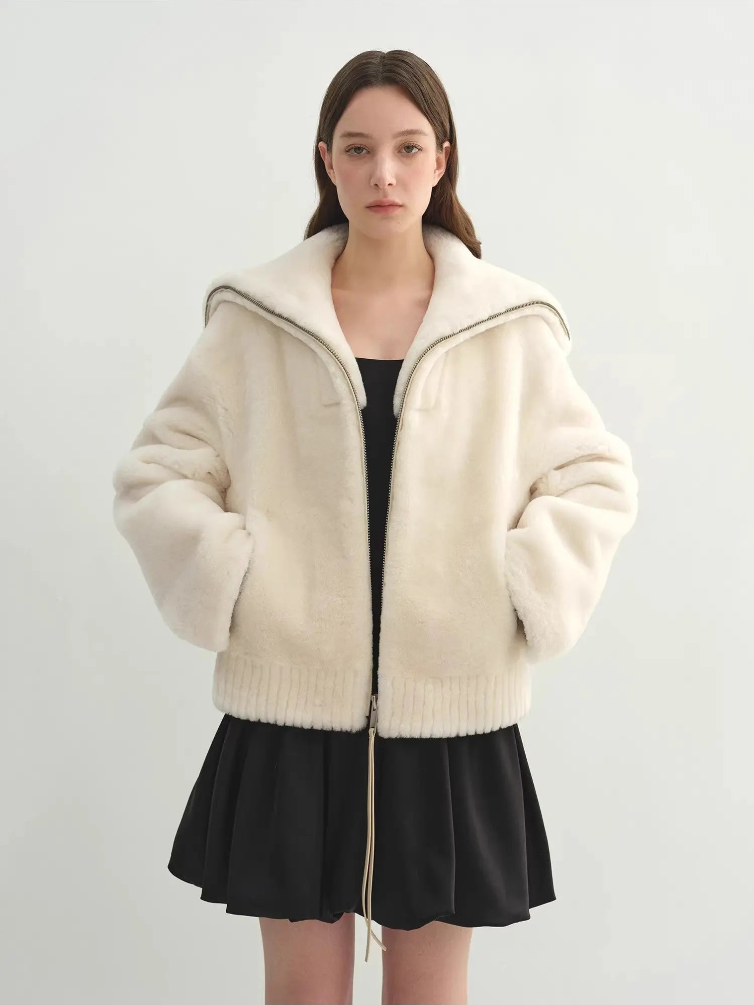 Model wearing the Butter Crisp pearl white Merino shearling leather coat, relaxed front view