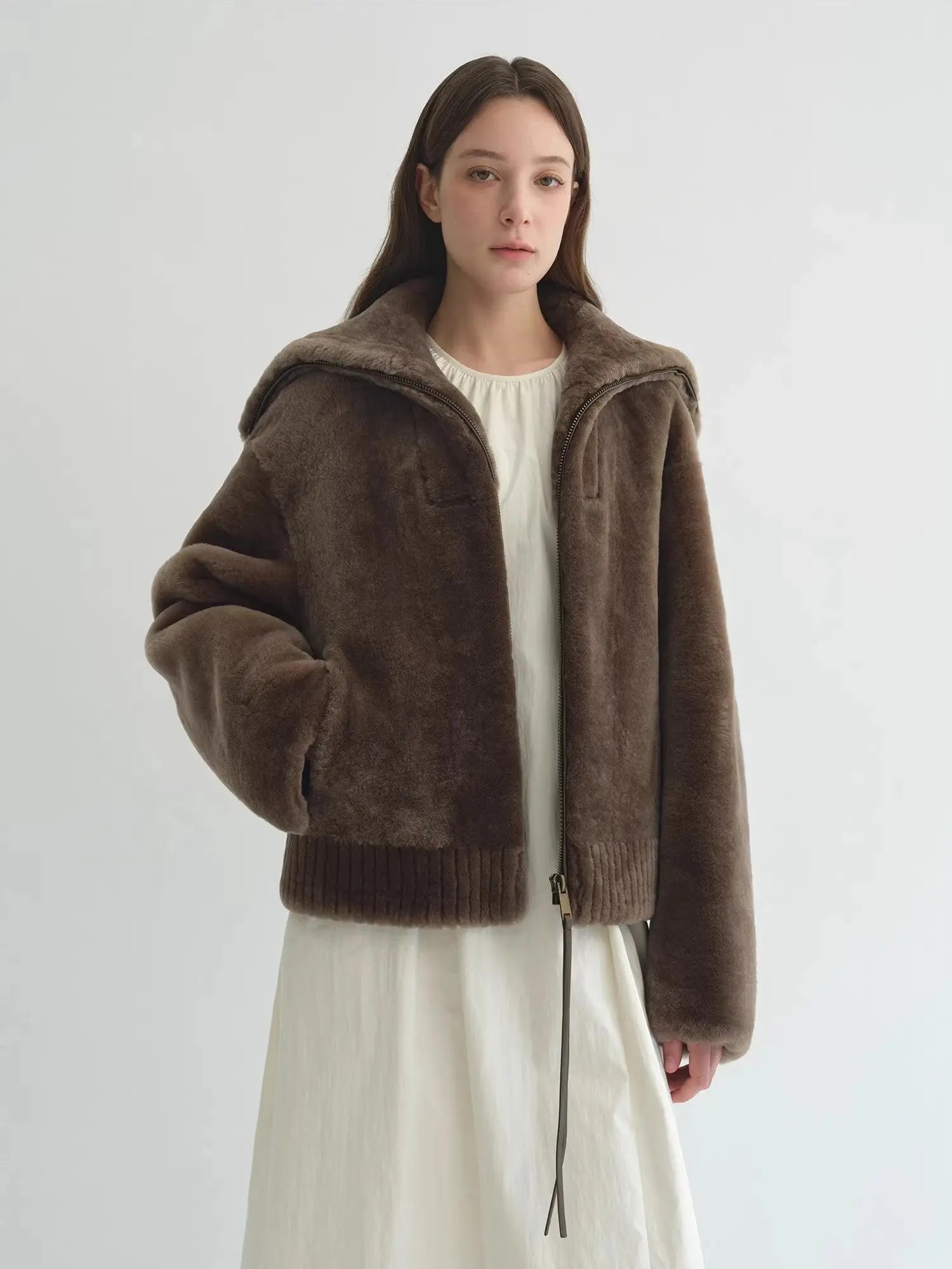 Model wearing the Butter Crisp smoked oak Merino shearling leather coat, front view