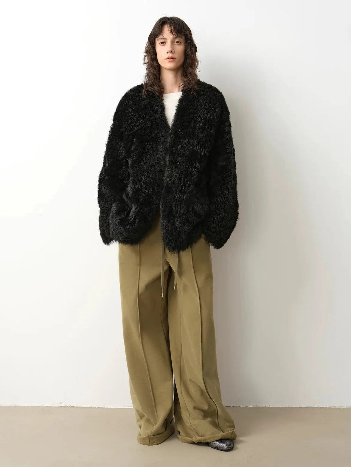 Model wearing the Castle Dusk black V-neck Toscana shearling coat, full-length view
