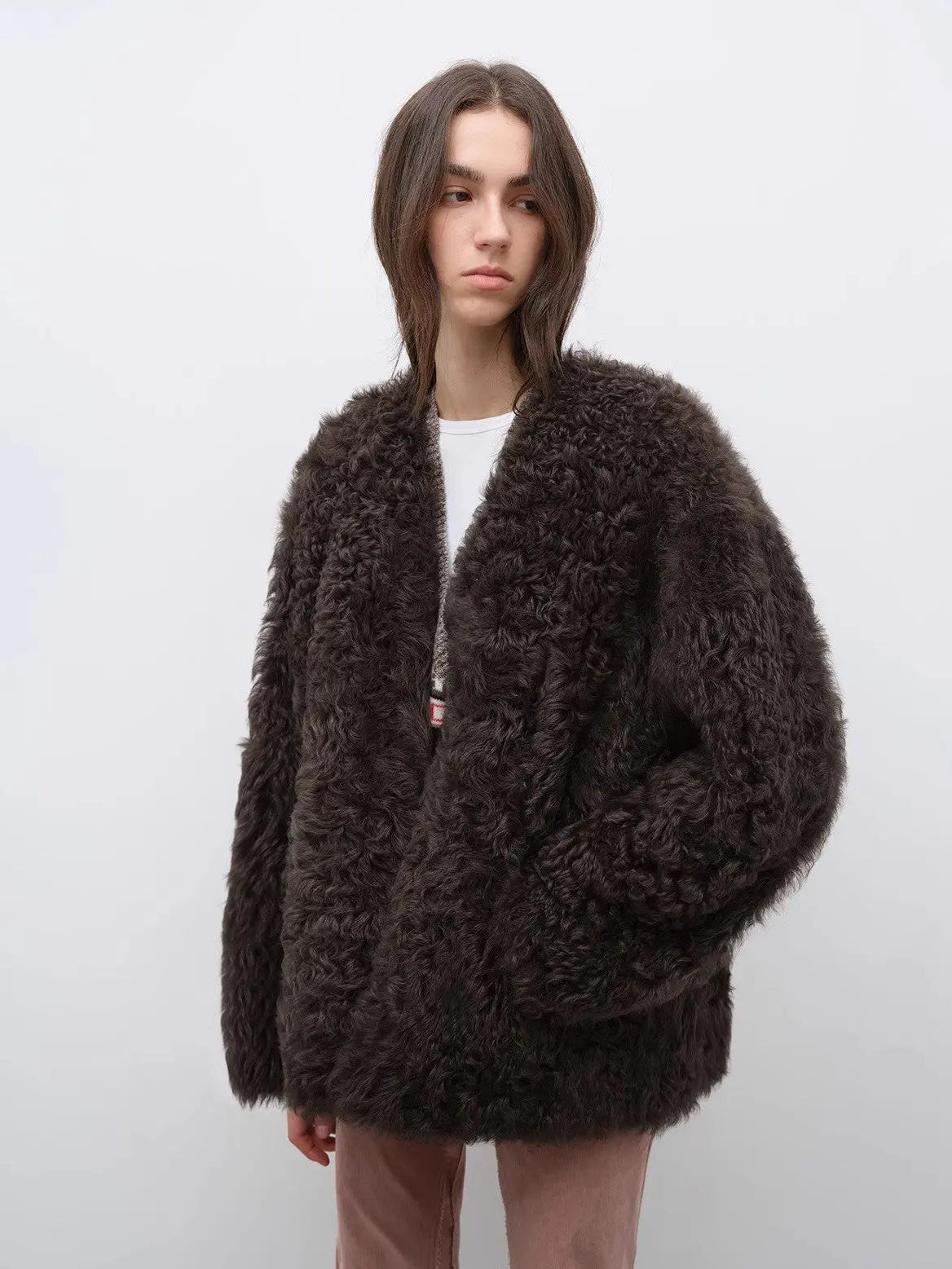 Model wearing the Castle Dusk camel brown V-neck Toscana shearling coat, close front view