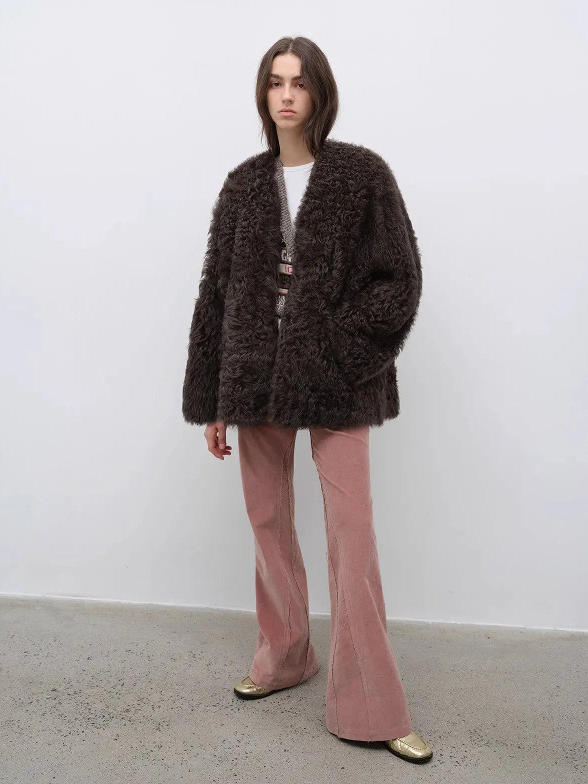 Model wearing the Castle Dusk camel brown V-neck Toscana shearling coat, full-length view