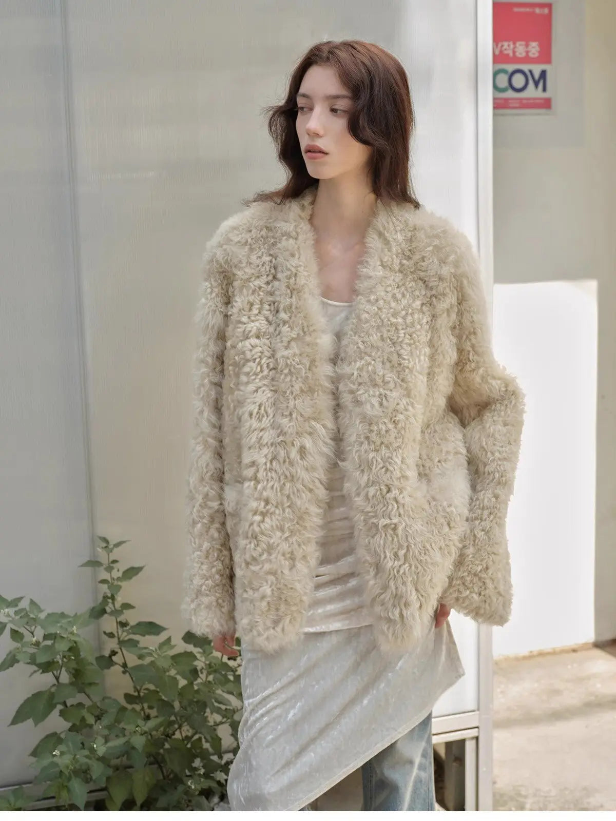 Model styling the Castle Dusk natural ivory V-neck Toscana shearling coat, close view