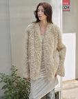 Model styling the Castle Dusk natural ivory V-neck Toscana shearling coat, close view
