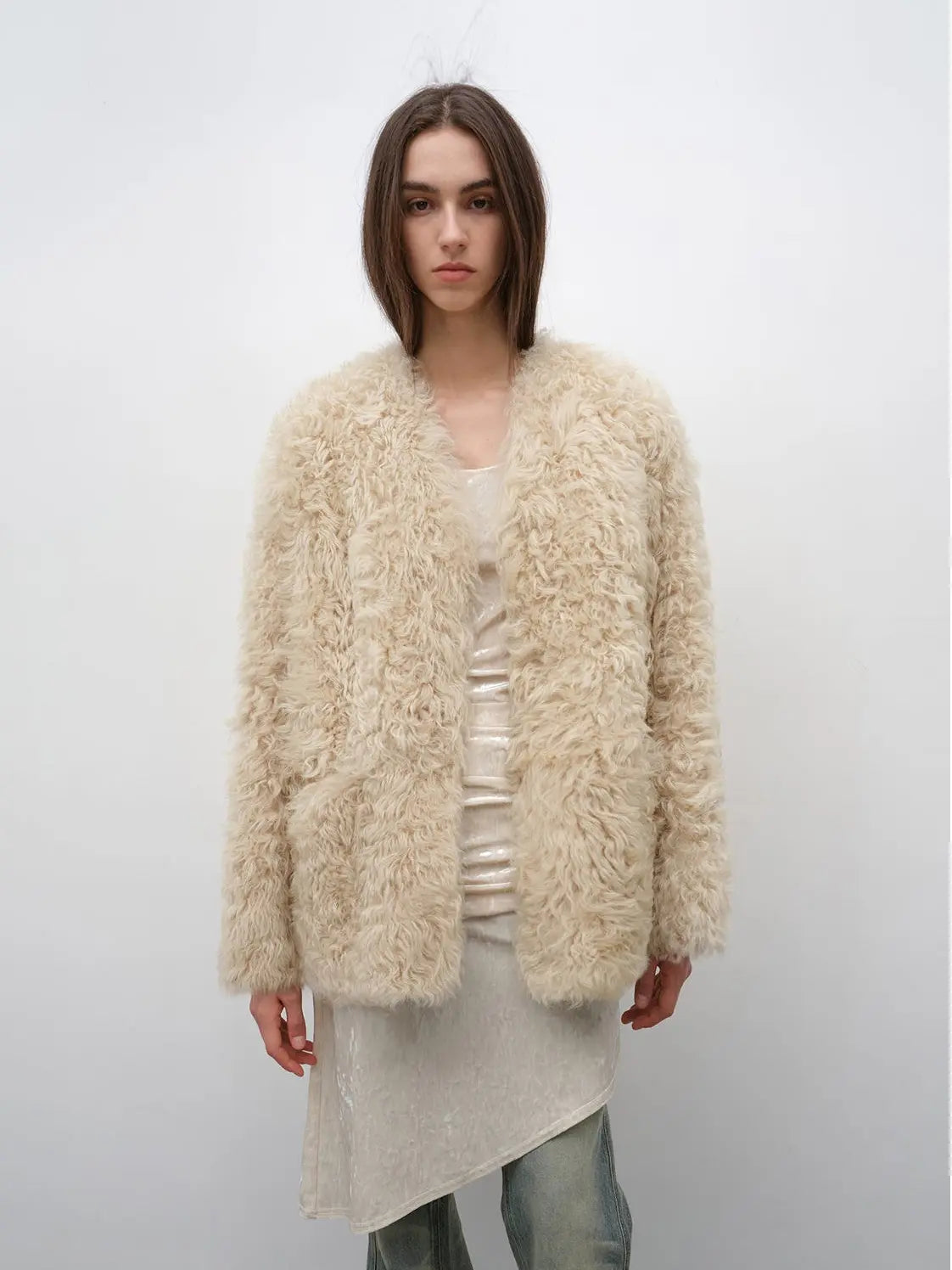 Model wearing the Castle Dusk natural ivory V-neck Toscana shearling coat, front view